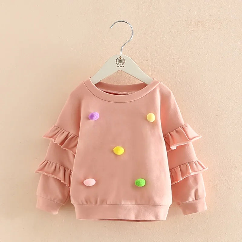 Pink Girls Pom Pom Jumper with ruffled sleeves for ages 2-10, stylish and comfortable children's clothing from Bijou Bubs